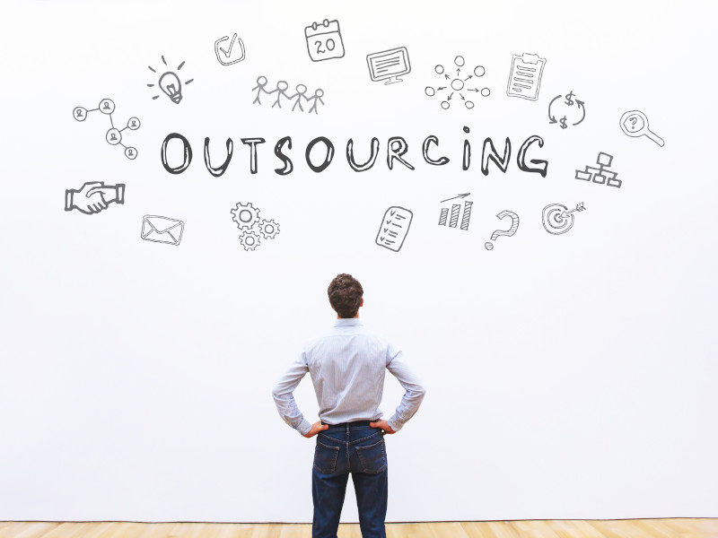 Man looking at word outsourcing